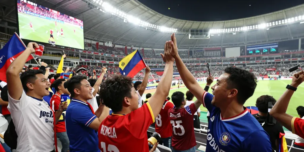 Fans celebrating during a thrilling jebolwd sports event in a vibrant stadium.